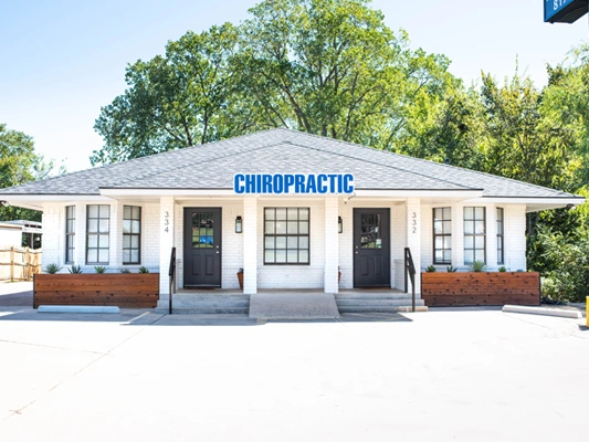 Front view of a small white brick chiropractic clinic