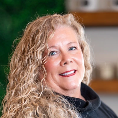 Close-up portrait of a person with curly blonde hair