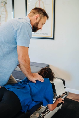 Chiropractor performing a hands-on spinal adjustment